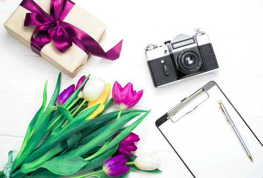 flowers gift and camera on a white background