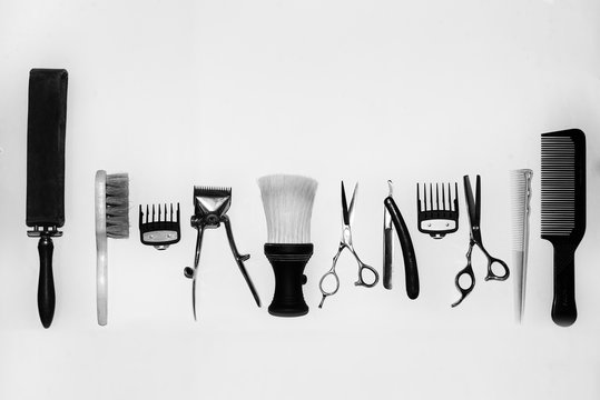 Vintage black and white photo with the tools of a hairdresser. In the photo there is fine grain.