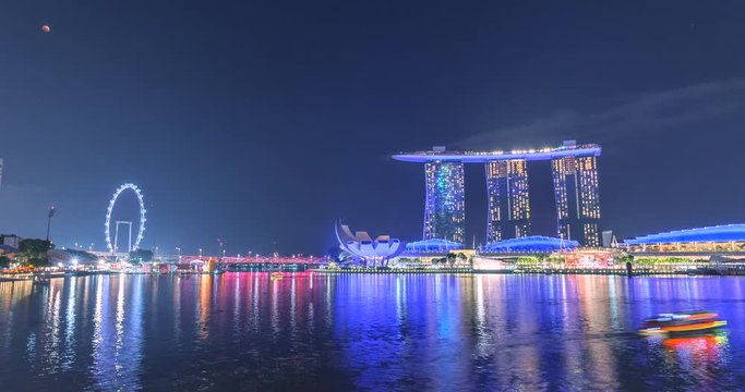 4k Timelapse Laser Show of Singapore City Skyline and Financial district across Marina Bay under a beautiful blue sky in Singapore