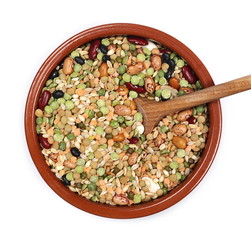 Mixed dried legumes and cereals in clay bowl and wooden spoon isolated on white background