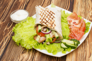 Shawarmas on lettuce isolated a wooden background