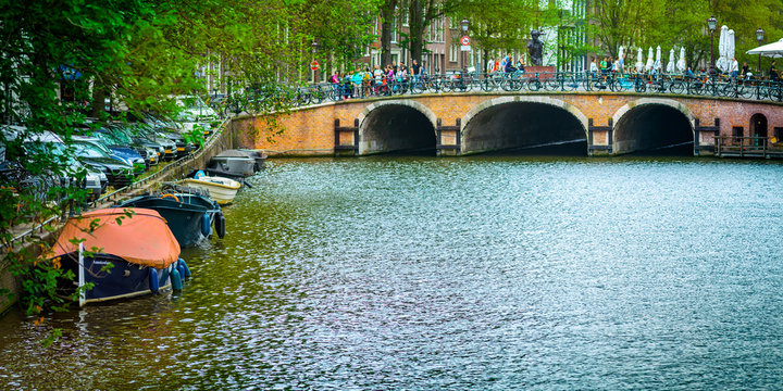 Wonderful view of Amsterdam canals with their bridges and bikes, Holland