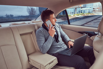 A handsome businessman in luxury car