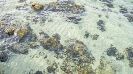 Travel, cliff next to the Mediterranean Sea, strong waves break with the rocks and leave blue and turquoise colors along with the foam of the sea.