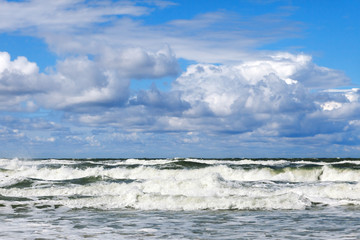 Storm at sea and a beautiful sky with Cumulus clouds.