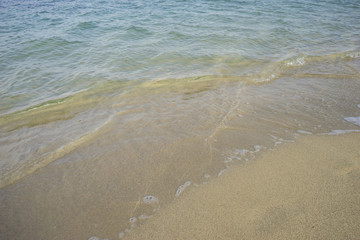 Journey Mediterranean scene, shore of the Mediterranean Sea with barefoot footprints of people in summer
