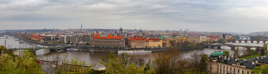 Fototapeta na wymiar Prague wide panoramic view with old town and river from hill with a park. Gloomy weather.