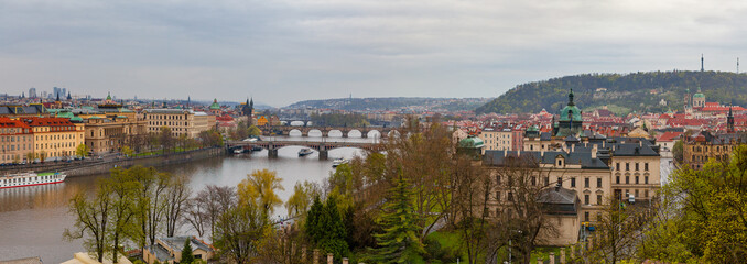 Prague wide panoramic view with old town and river from hill with park Letensky garden. Gloomy weather.