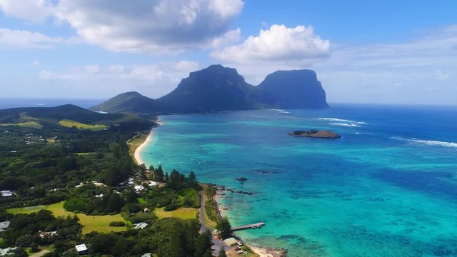 Aerial view of Lord Howe Island (World Heritage-listed paradise), turquoise blue lagoon and Mount Gower on background - New South Wales - Tasman Sea - Australia from above, 4k UHD