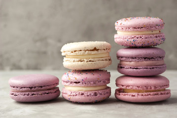 Colorful gentle macarons on grey background.