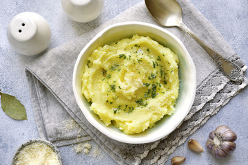 Potato mash with olive oil,parmesan cheese and greens.Top view.