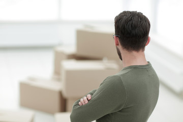 rear view.man standing in new house