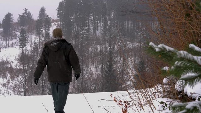 Man goes to snowy forest - (4K)