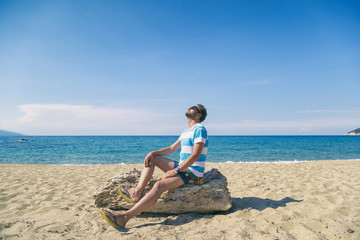 Tourist handsome man enjoying on the tropical beach. Summer concept.