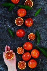 Juicy Blood Oranges on the dark background. Blood oranges isolated. Top view, flat lay
