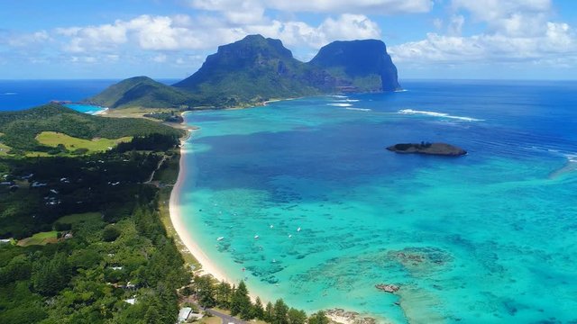 Aerial view of Lord Howe Island (World Heritage-listed paradise), turquoise blue lagoon and Mount Gower on background - New South Wales - Tasman Sea - Australia from above, 4k UHD