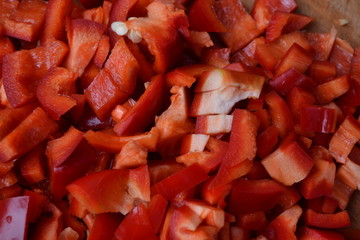 Pepper. Capsicum annuum. Slices of red pepper. Close-up. Splitting. On a cutting board. Kitchen. Cooking food. Delicious. Horizontal photo