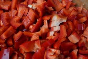 Pepper. Capsicum annuum. Slices of red pepper. Close-up. Splitting. On a cutting board. Kitchen. Cooking food. Horizontal