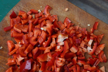 Pepper. Capsicum annuum. Slices of red pepper. Close-up. Splitting. On a cutting board. Kitchen. Delicious. Horizontal