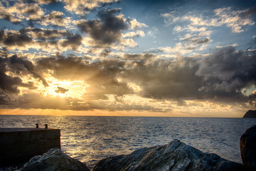 Obraz premium Sunset over the ocean on the coast in Italy