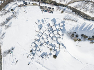 Aerial view of snow covered rooftops in mountain village in winter