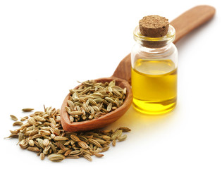 Fennel seeds with essential oil in a bottle
