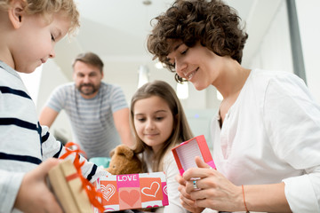 Portrait of happy young family with two children celebrating Valentines day  at home
