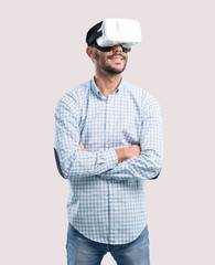 Satisfied young man using virtual reality glasses