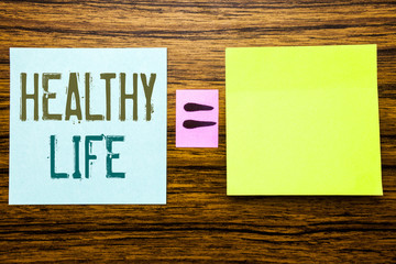 Word, writing Healthy Life. Business concept for Good Health Food written on sticky note paper on wooden background. Equation mathematical sign for your space
