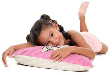 Multiracial small girl smiling laying on a cushion on the floor