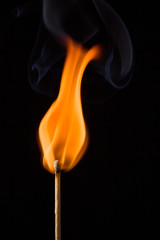 Wooden match on black background