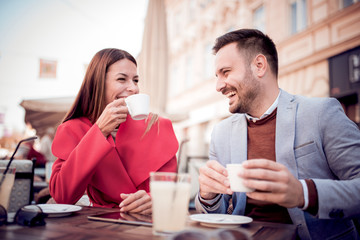Portrait of happy couple dating at coffee shop.