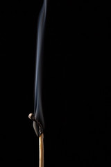 Wooden match on black background