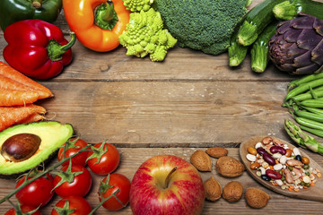 vegan word on wood background and vegetable - food