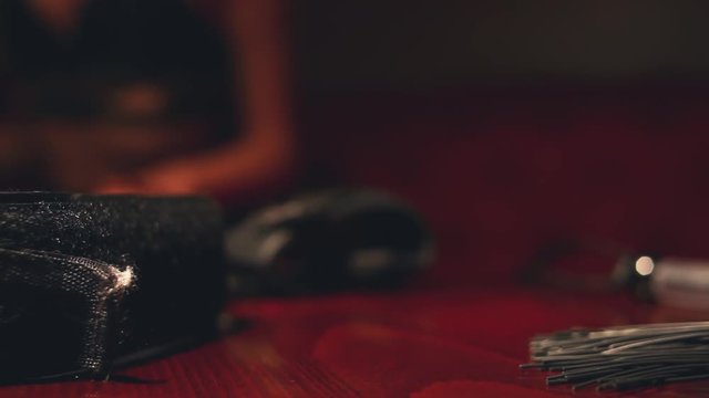 the girl runs a whip on the table. Intimate goods.  Whip for intimacy. 
