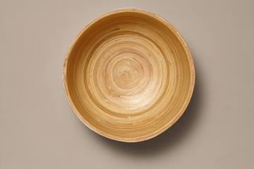 Empty wooden bamboo Bowl isolated on Grey Background with Real Shadow. Top View with Copy Space for...