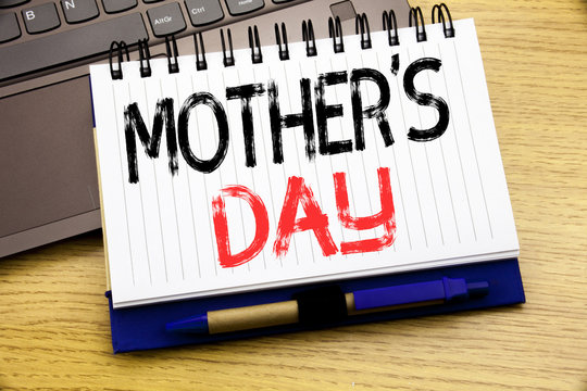 Word, writing Mother Day. Business concept for Mom Greetings Celebration written on notebook book on the wooden background in the Office with laptop