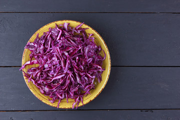 Sliced purple cabbage in clay pots, purple cabbage on a dark wooden background, sliced cabbage in the style of minimalism, vegetables in rustic style, vegetarian product, vitamins, healthy food