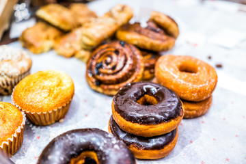 Many different selection of pastry dessert sweets for continental breakfast, chocolate fried...