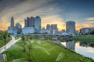 Skyline along the Scioto River showcasing the Leveque Tower and Supreme Court building with sprinklers activated. 