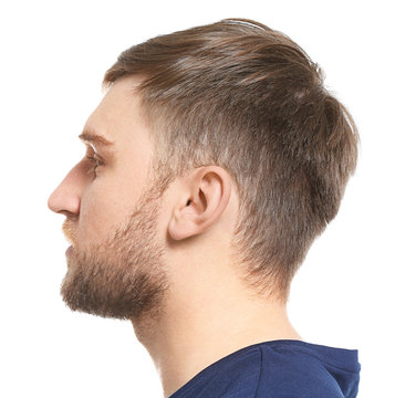 Young man on white background. Hearing problem