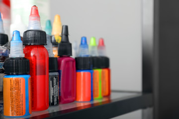 Many bottles with ink in tattoo salon