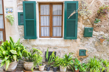 old window in a coastal village of the island of Mallorca in Spain, next to the mediterranean sea, vacation and rest concept