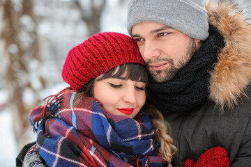 Fototapeta premium Portrait of young loving couple outdoors on winter day