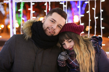 Fototapeta premium Portrait of young loving couple outdoors on Christmas eve