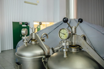 Manometer on the cylinder with gas in modern brewery. Close-up view.