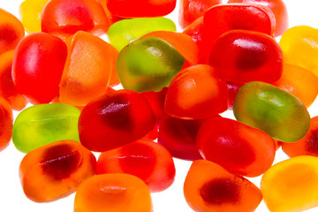 Colored fruit jelly beans on white background