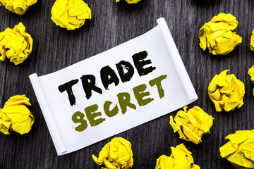 Naklejka premium Writing text showing Trade Secret. Business concept for Data Protection Written on sticky note notepad note notebook book wooden background with yellow sticky folded.