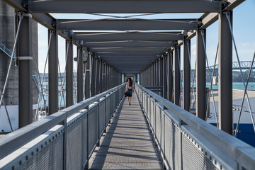 Professional/Business Woman in modern metal corridor/rooftop walk