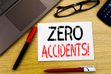 Conceptual hand writing text showing Zero Accidents. Business concept for Safety At Work Hazard written on paper, wooden background in office with copy space, marker pen and glasses